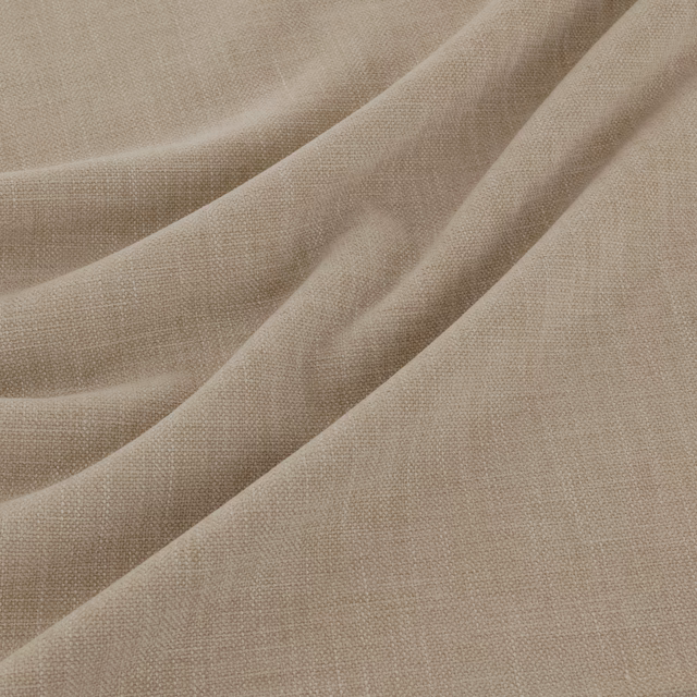 Warm flax-beige plain weave fabric draped in soft folds with fine visible texture