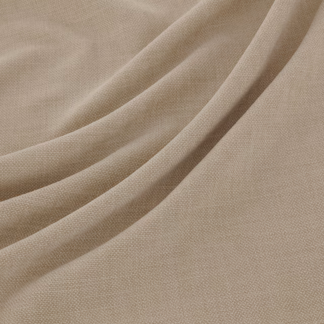 Warm beige Esperia fabric showing an even plain weave and softly draped folds