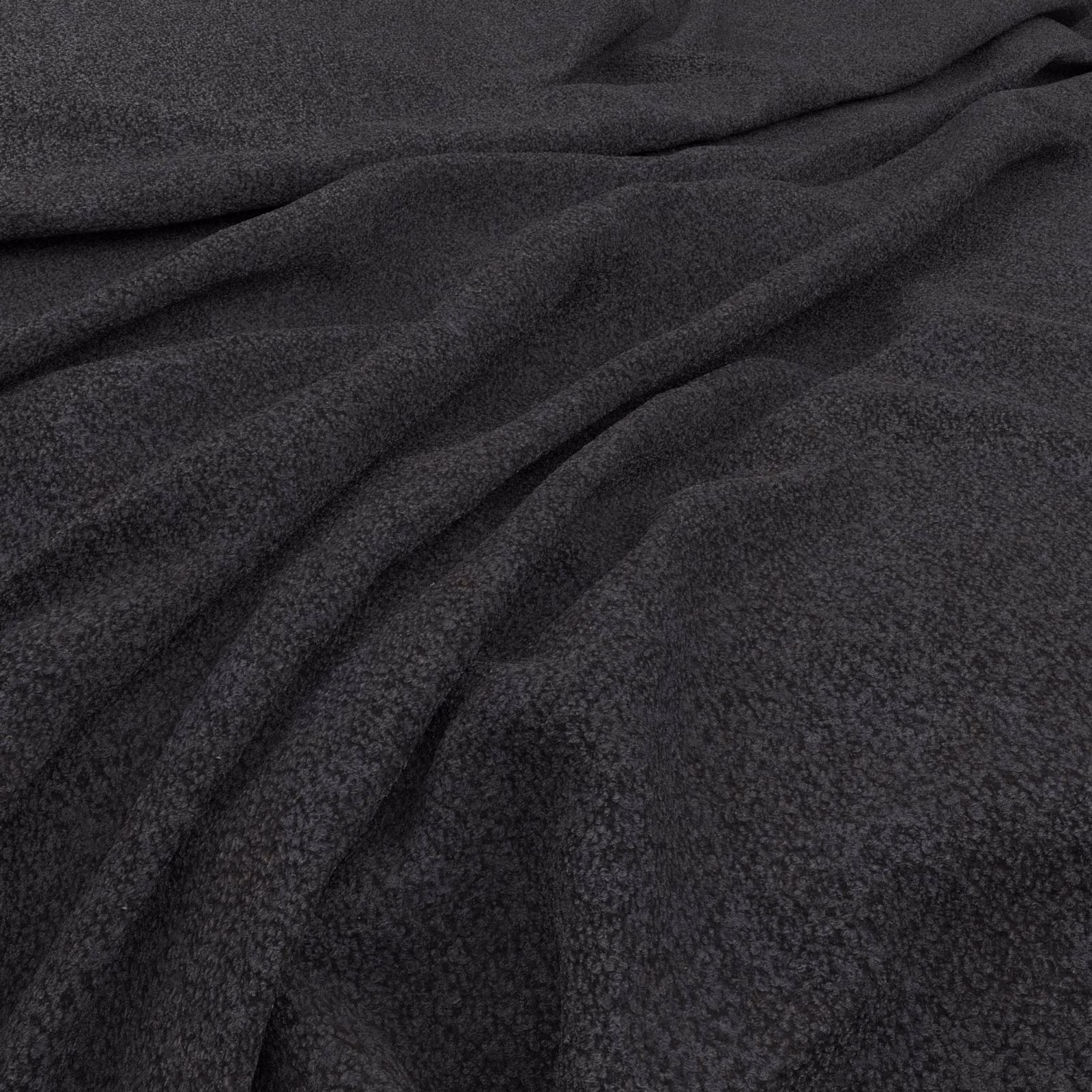 Deep indigo fabric with a finely mottled surface arranged in soft flowing folds