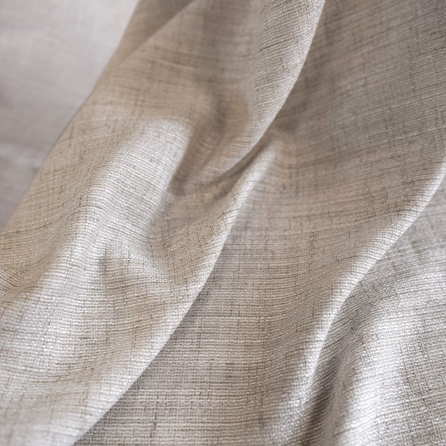Cream crosshatch weave falling in softly lit, fluid folds