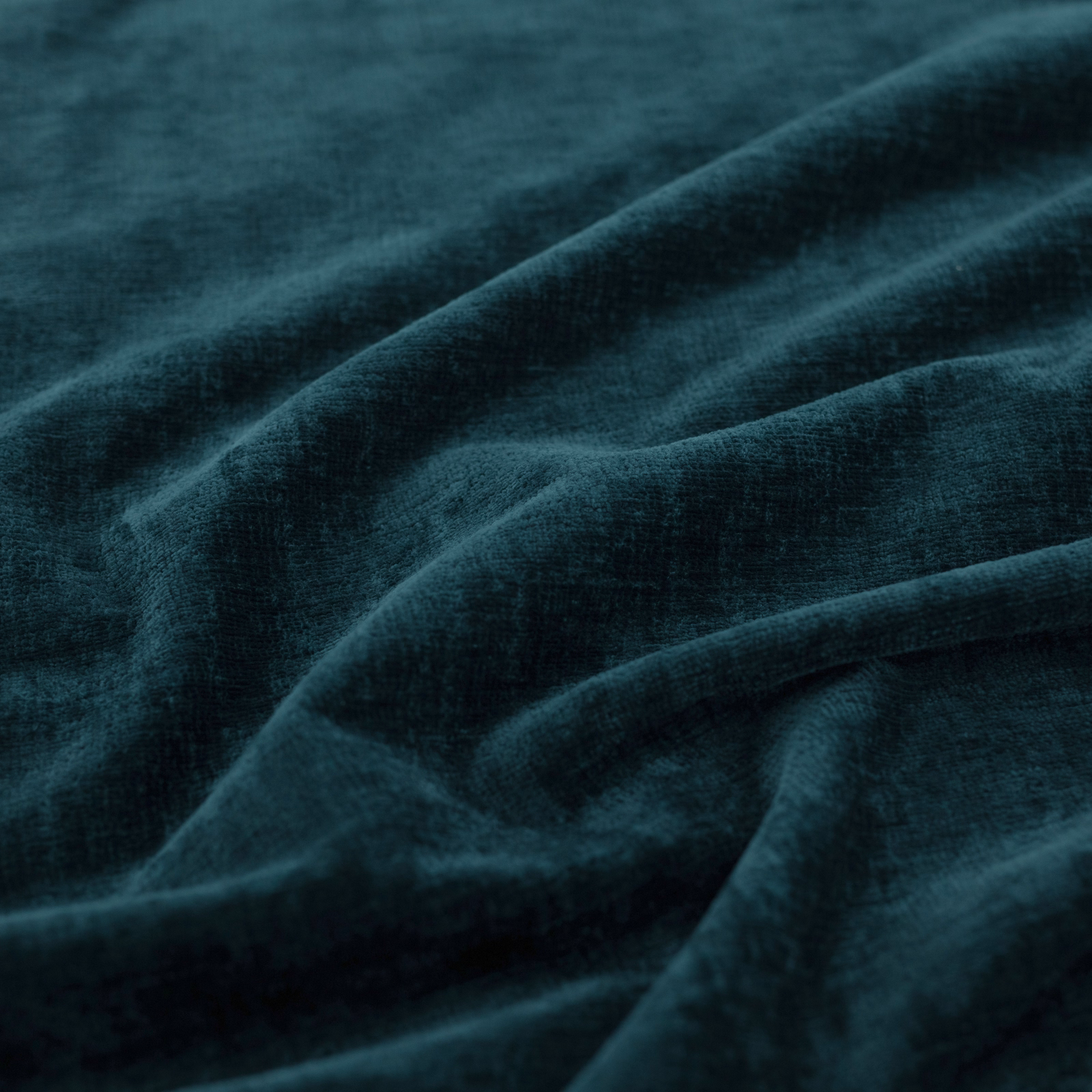 Deep Prussian teal plain upholstery fabric with soft brushed texture and folded drape