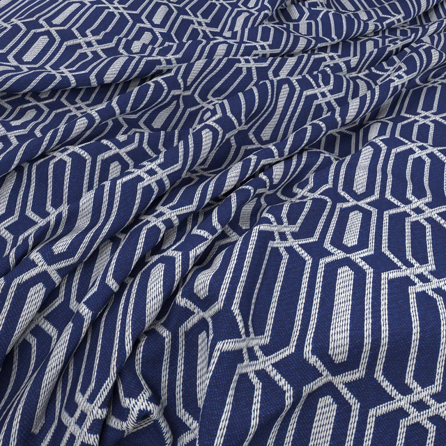 Textured blueberry-blue fabric with raised ivory interlocking geometric motifs