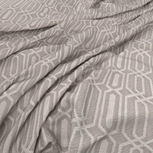 Warm taupe-grey woven fabric with ivory elongated hexagon geometric pattern