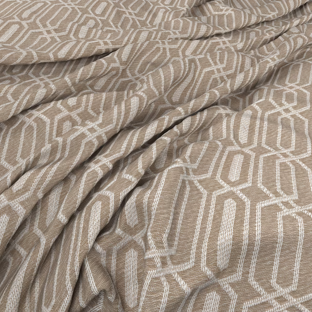 Warm taupe woven fabric with ivory angular geometric lines gathered into soft folds