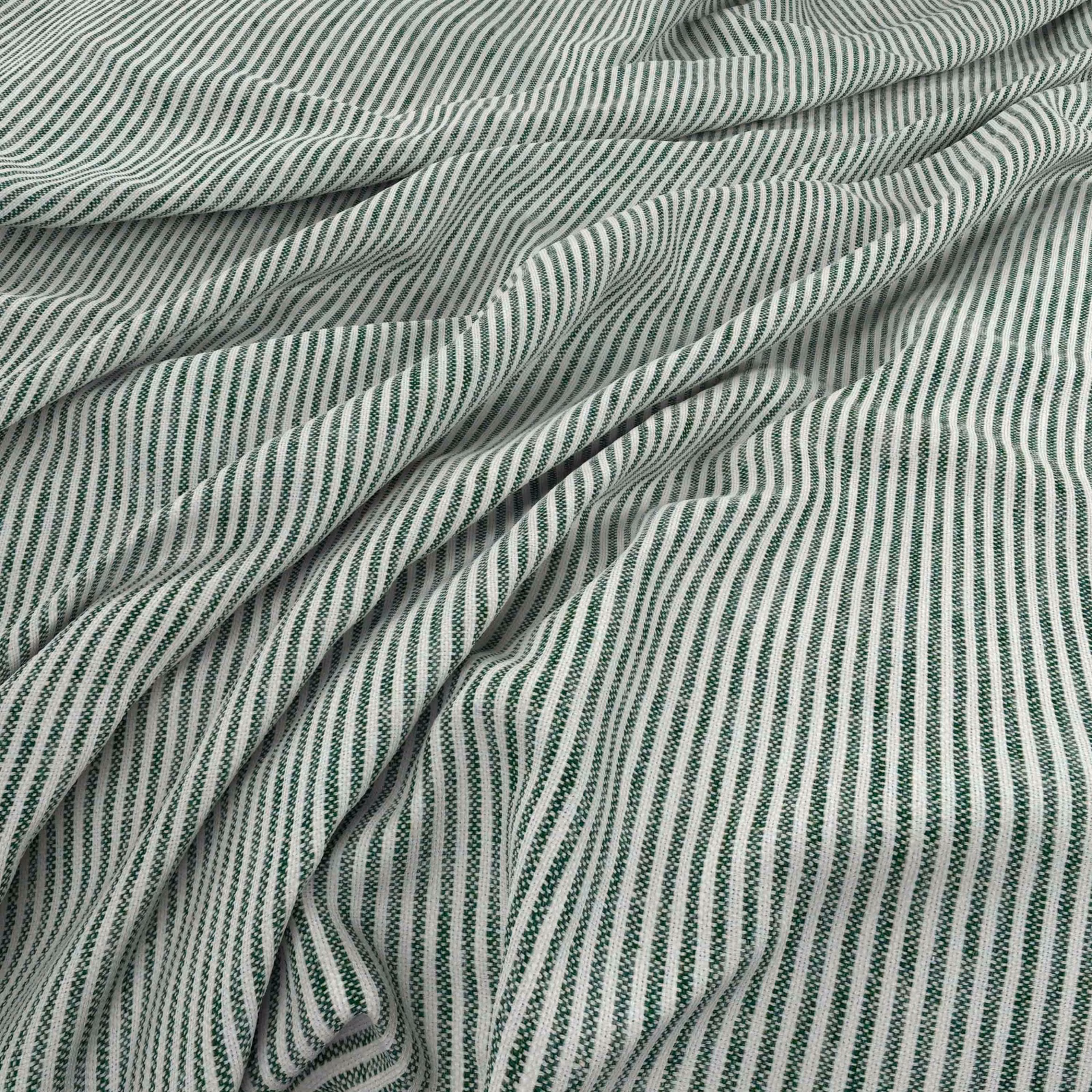 Close view of Filey Clover’s narrow ivory and muted green rippling stripes