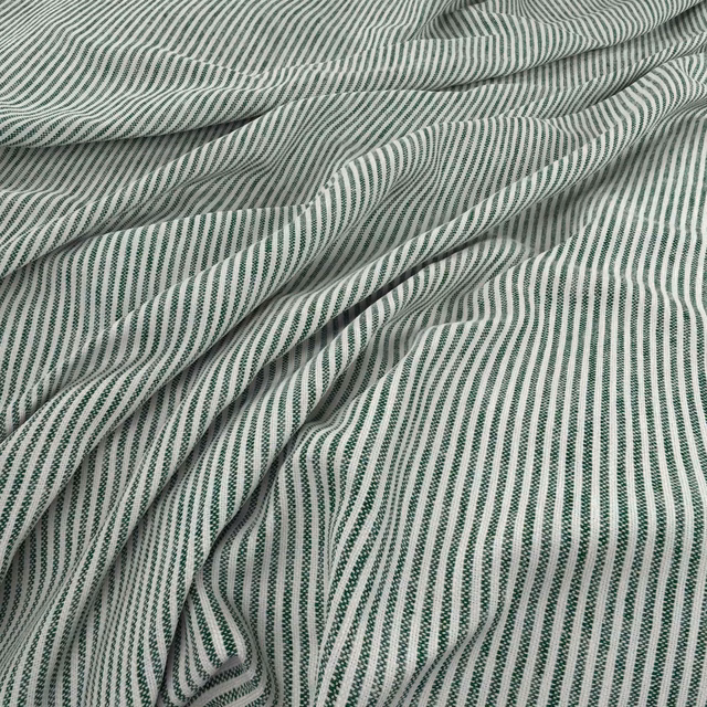 Close view of Filey Clover’s narrow ivory and muted green rippling stripes