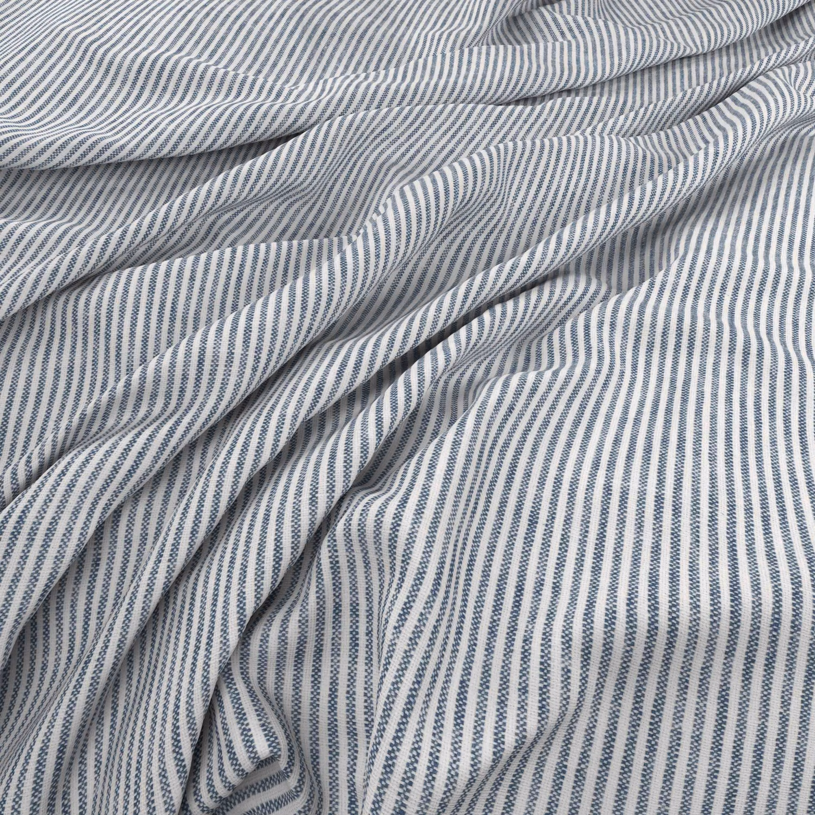 Cool Delft-blue and white pinstripes gathered into soft fluid folds