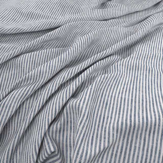 Cool Delft-blue and white pinstripes gathered into soft fluid folds