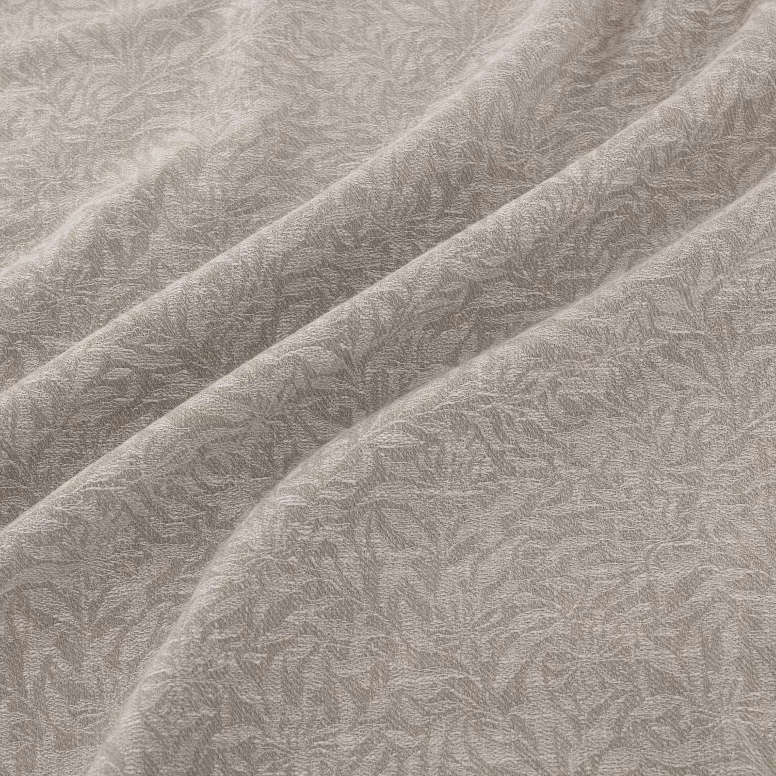 Soft silver-grey fabric with a fine leafy filigree weave across diagonal folds