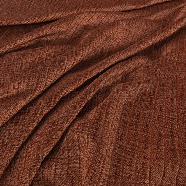 Warm copper-brown fabric with fine ribbed lines and softly rippled folds