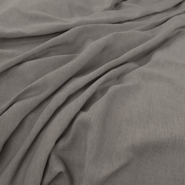 Soft fog-grey plain weave fabric gathered into fluid, shadowed folds