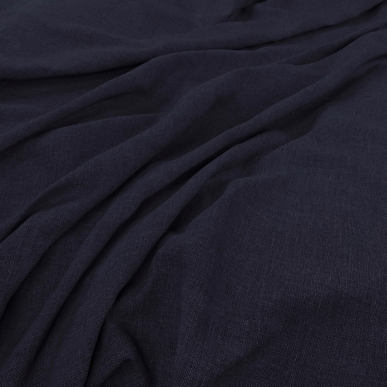 Dark ink navy plain-weave fabric gathered into softly shadowed folds