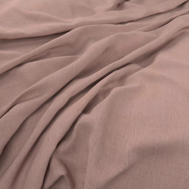 Dusty blush-pink plain-weave fabric draped into soft, fluid folds
