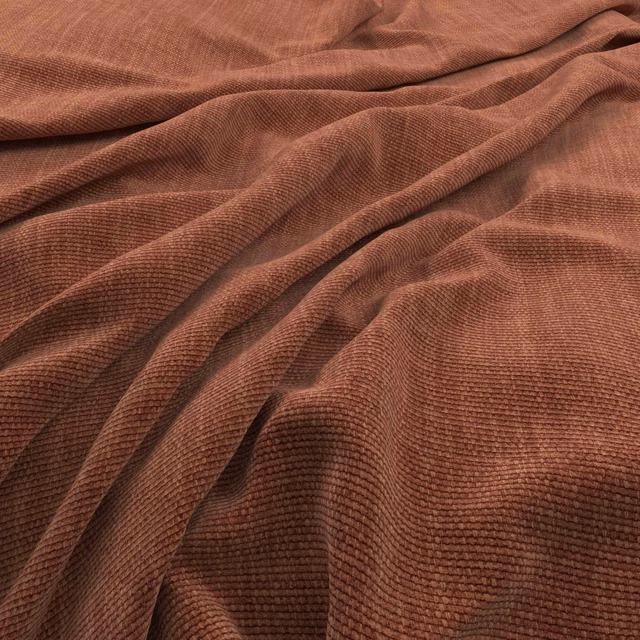Warm henna-brown ribbed textile gathered into soft, shadowed folds