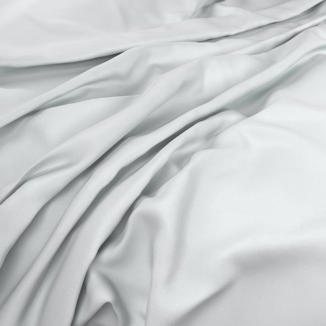 Cool snowy white fabric falling in smooth, softly lustrous fluid folds