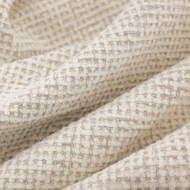 Warm ivory woven swatch with taupe flecks and raised nubby texture