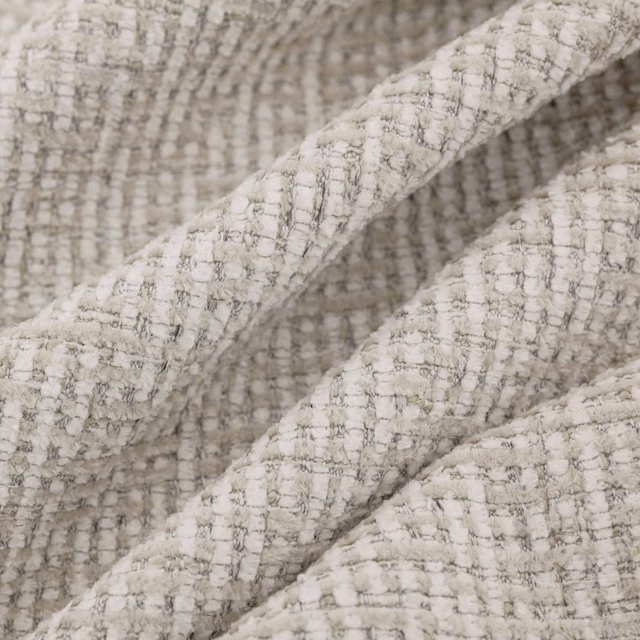 Close-up of warm oyster cream woven fabric with raised grey checked texture
