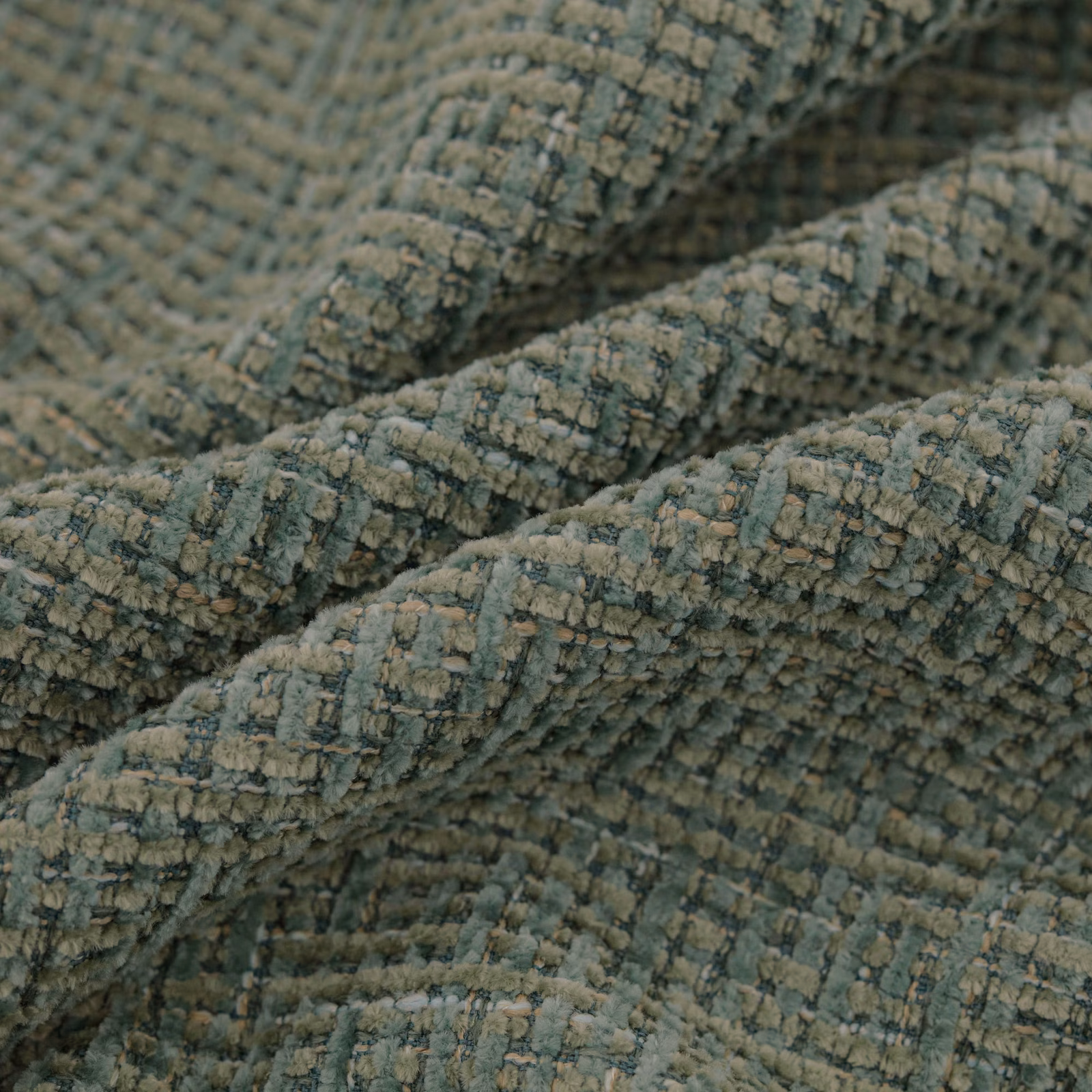 Close-up of muted seafoam woven fabric with raised, crinkled ribbed texture