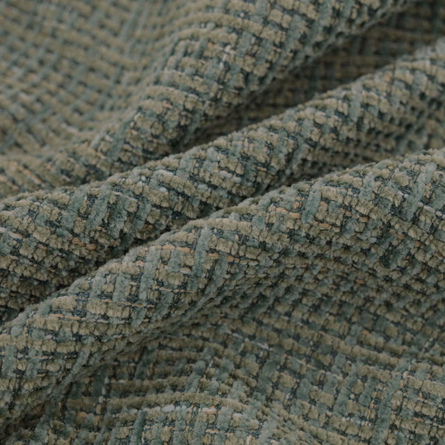 Close-up of muted seafoam woven fabric with raised, crinkled ribbed texture