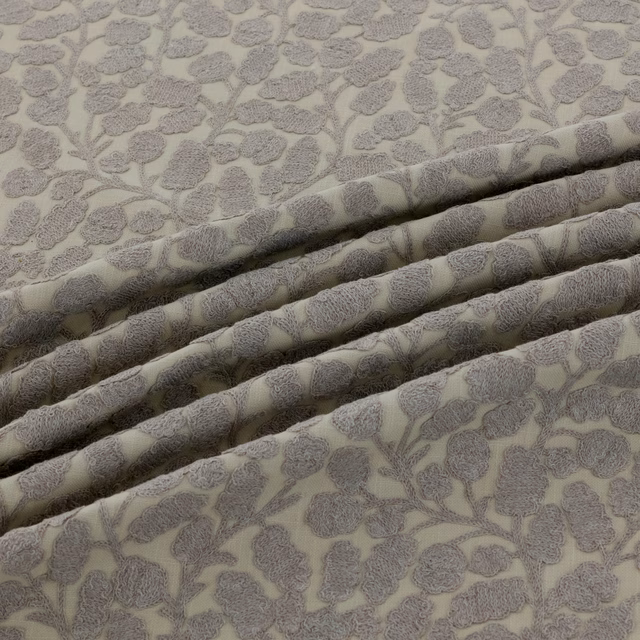 Warm greige floral fabric with raised grey blossoms and branching stems