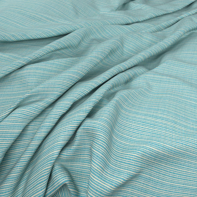 Cool aqua-blue fabric with fine pale ripples gathered into soft folds