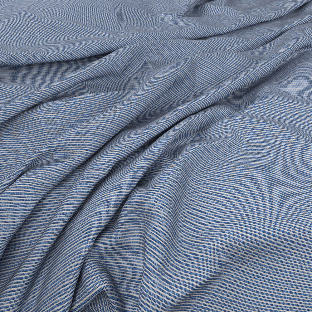 Cool blue-grey fabric with fine striped weave gathered into fluid folds