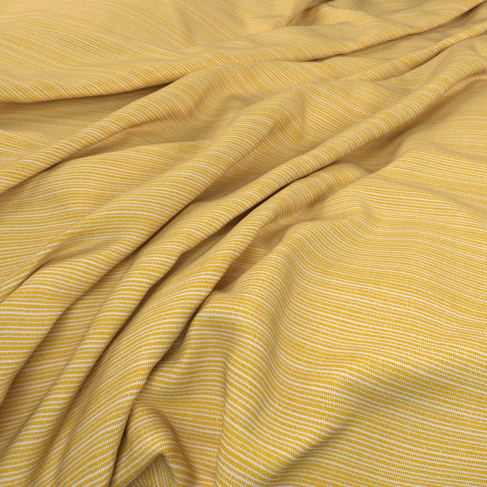 Warm golden-yellow fabric with fine cream ripples folding into soft waves