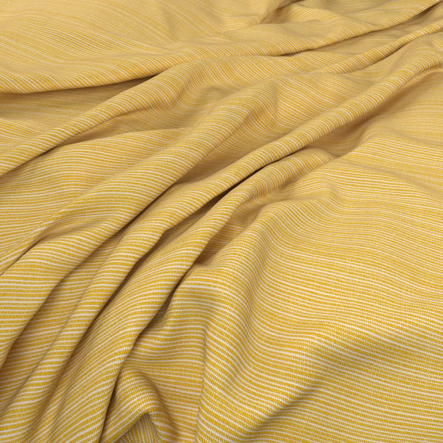 Warm golden-yellow fabric with fine cream ripples folding into soft waves