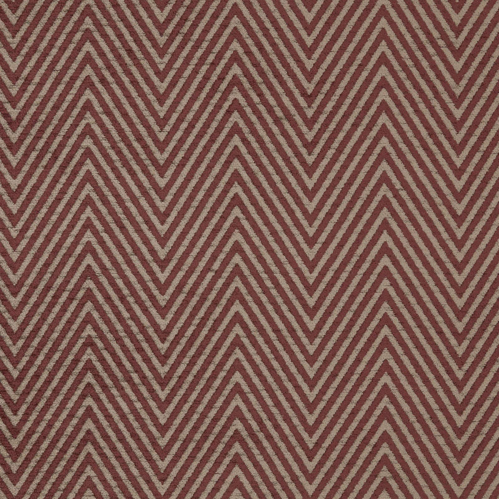 Close-up of a muted red and beige chevron woven upholstery fabric