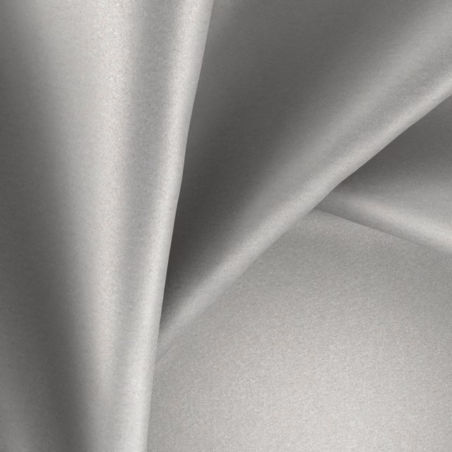 Cool silver-grey glossy fabric folded to show smooth sheen and fluid drape