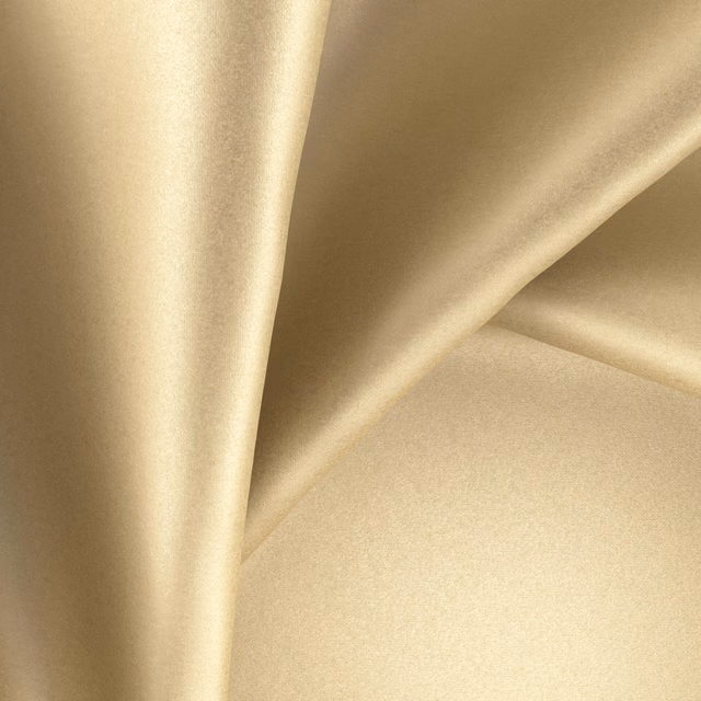 Warm citrine-gold plain fabric with a smooth surface and pronounced glossy highlights