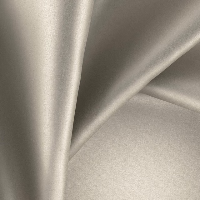 Mushroom taupe Glossy Fossilite fabric folded to show a soft lustrous sheen