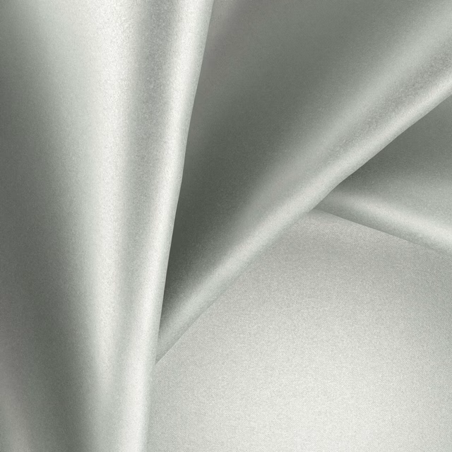 Pale glacier-grey green fabric with a cool sheen falling into soft folds