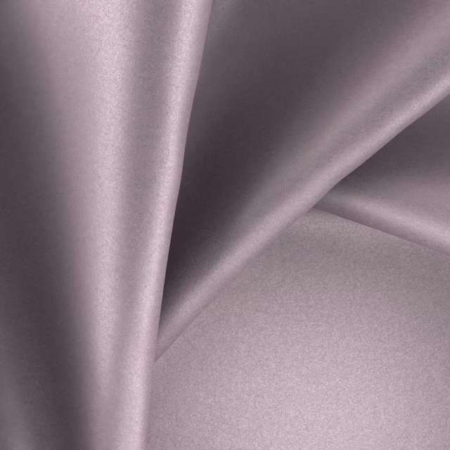Dusty mauve-lilac plain fabric with a smooth reflective surface in soft folds