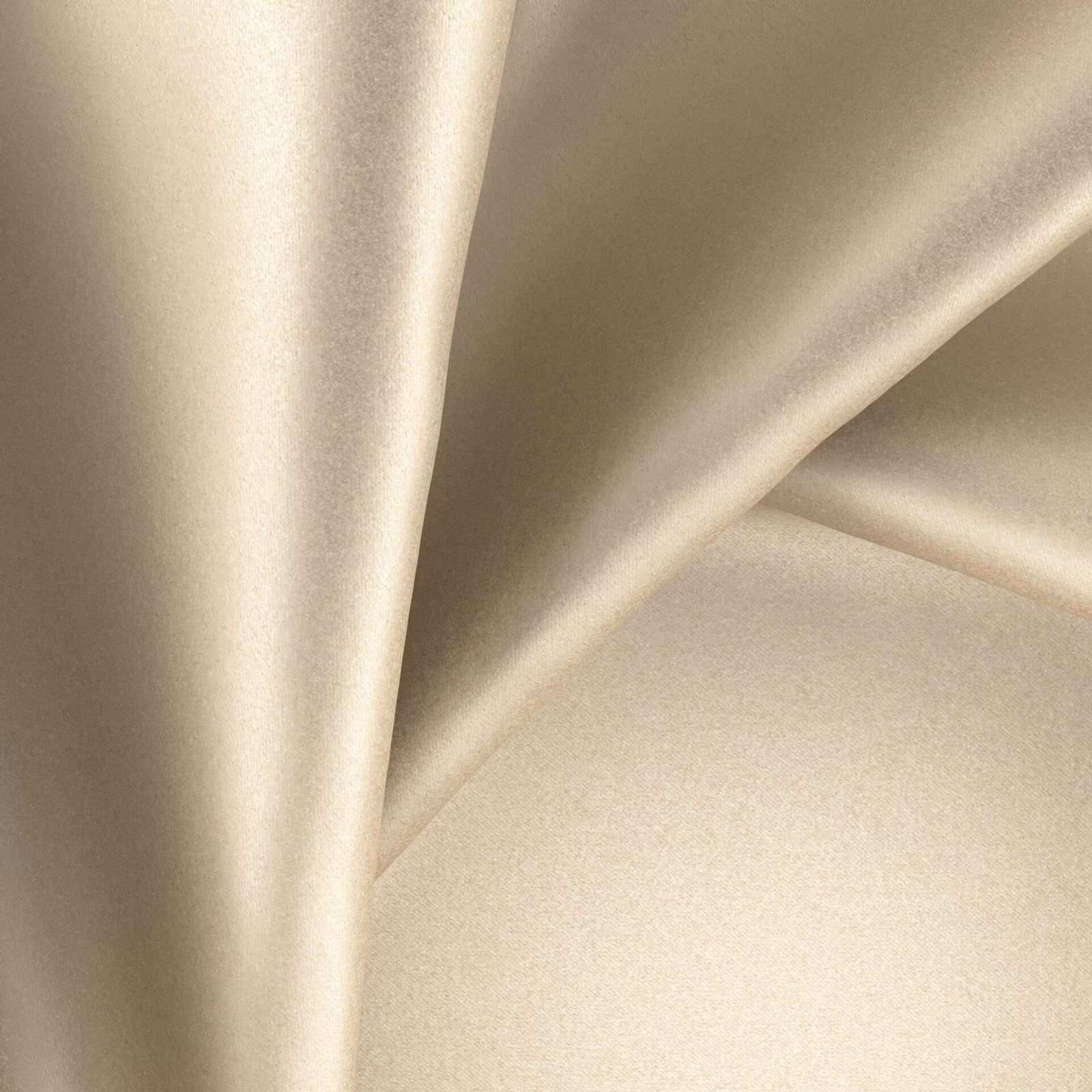 Warm champagne-beige glossy fabric draped in softly reflective folds