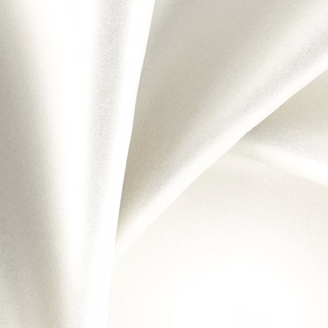 Luminous oyster cream fabric in soft folds with a subtle glossy sheen