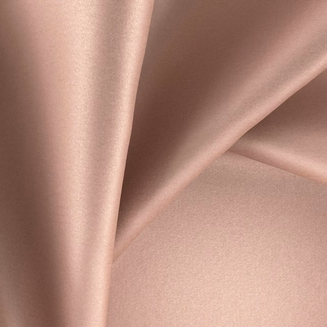 Dusty rose-pink Glossy fabric with smooth folds and a soft reflective sheen