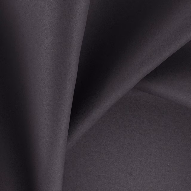 Dark charcoal-plum fabric with a smooth face and softly reflective folds