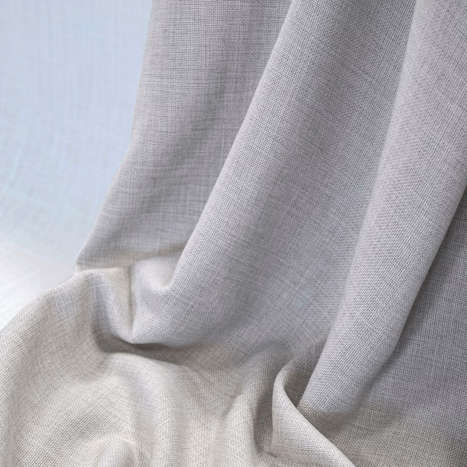 Pale grey-beige woven cloth falling in soft, fluid folds