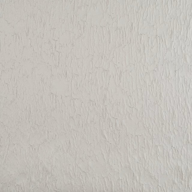 Pale sandstone-beige fabric with fine raised, irregular vertical striations and soft shadows