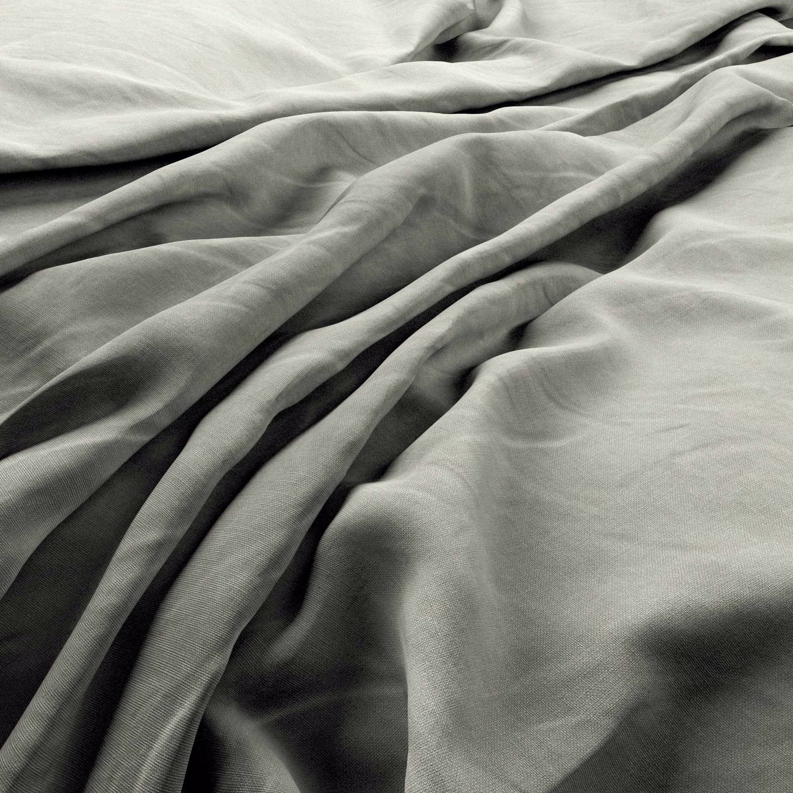 Soft mist-grey woven fabric gathered into deep, fluid folds with charcoal-toned shadows