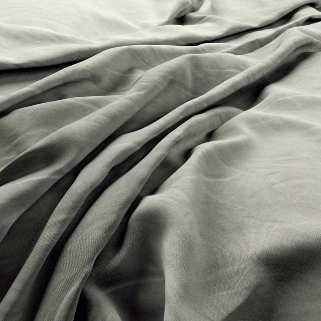 Soft mist-grey woven fabric gathered into deep, fluid folds with charcoal-toned shadows