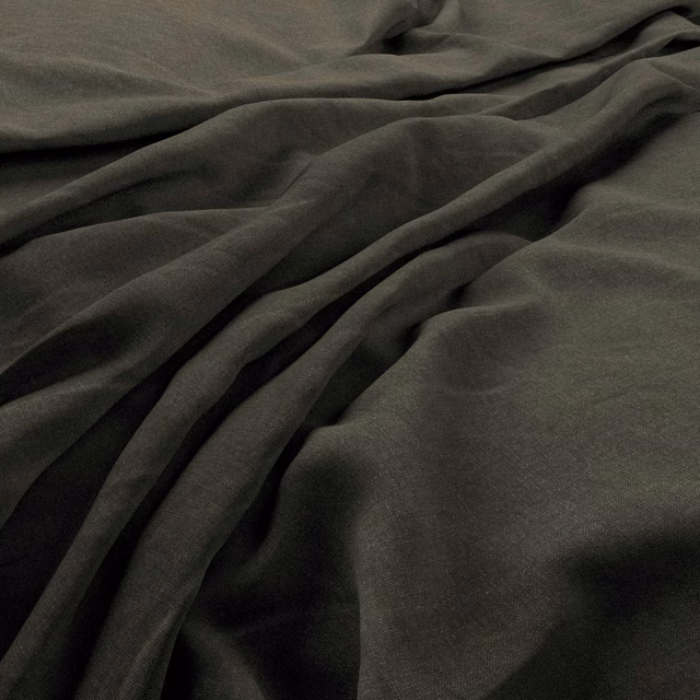 Deep smoky pine-green fabric in fluid folds, showing a fine plain weave