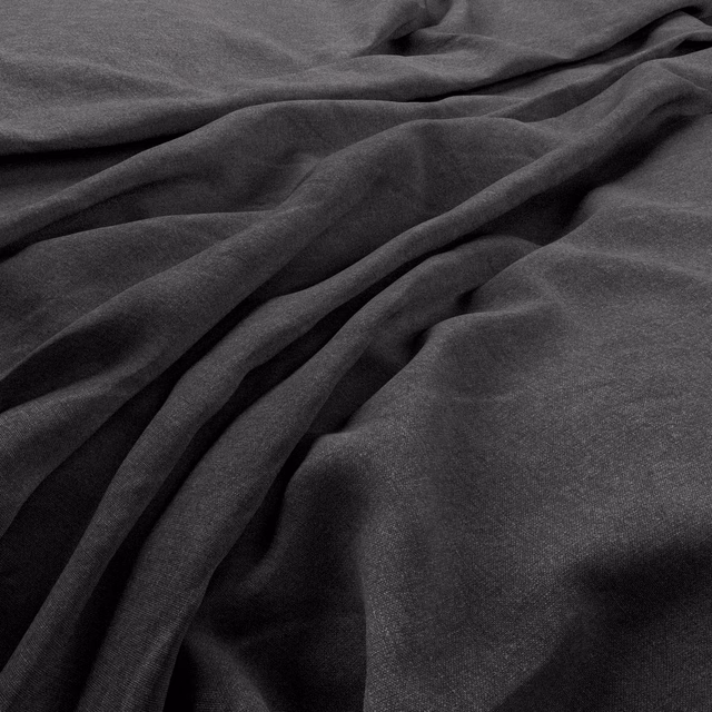 Deep charcoal-grey plain weave fabric arranged in soft, shadowed folds
