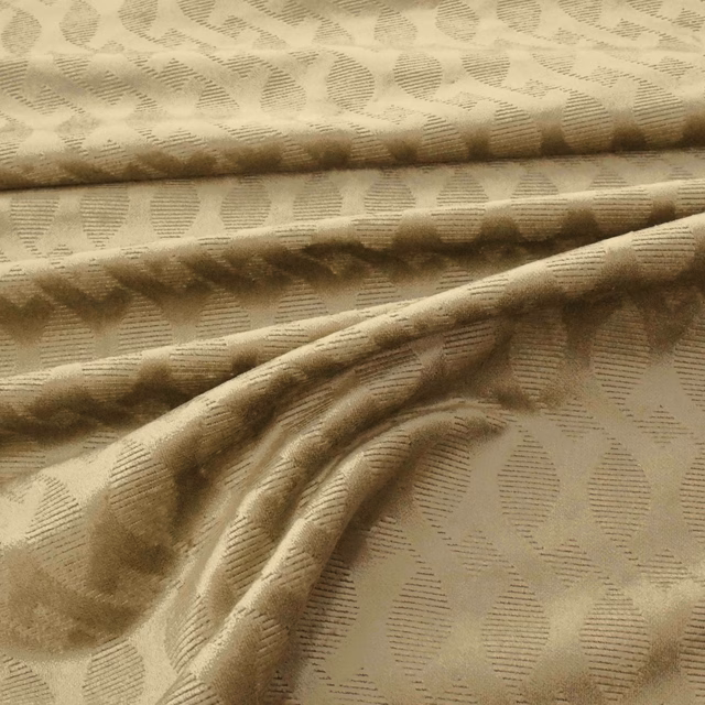 Muted antique-gold fabric with raised oval dash motifs and softly folded tactile texture