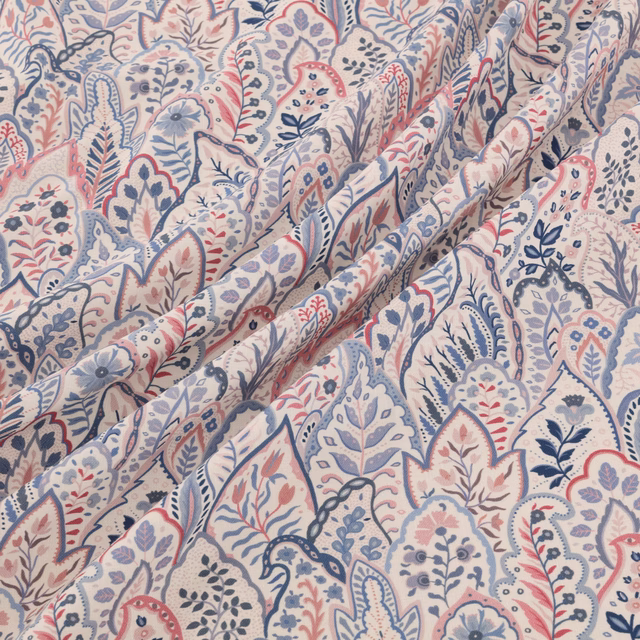 Cream paisley floral fabric with dusty blue, blush and slate motifs in soft folds