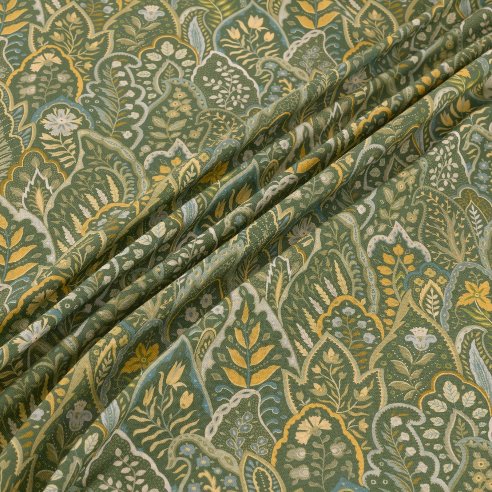 Muted kelp-green paisley fabric with ivory florals and ochre botanical detail