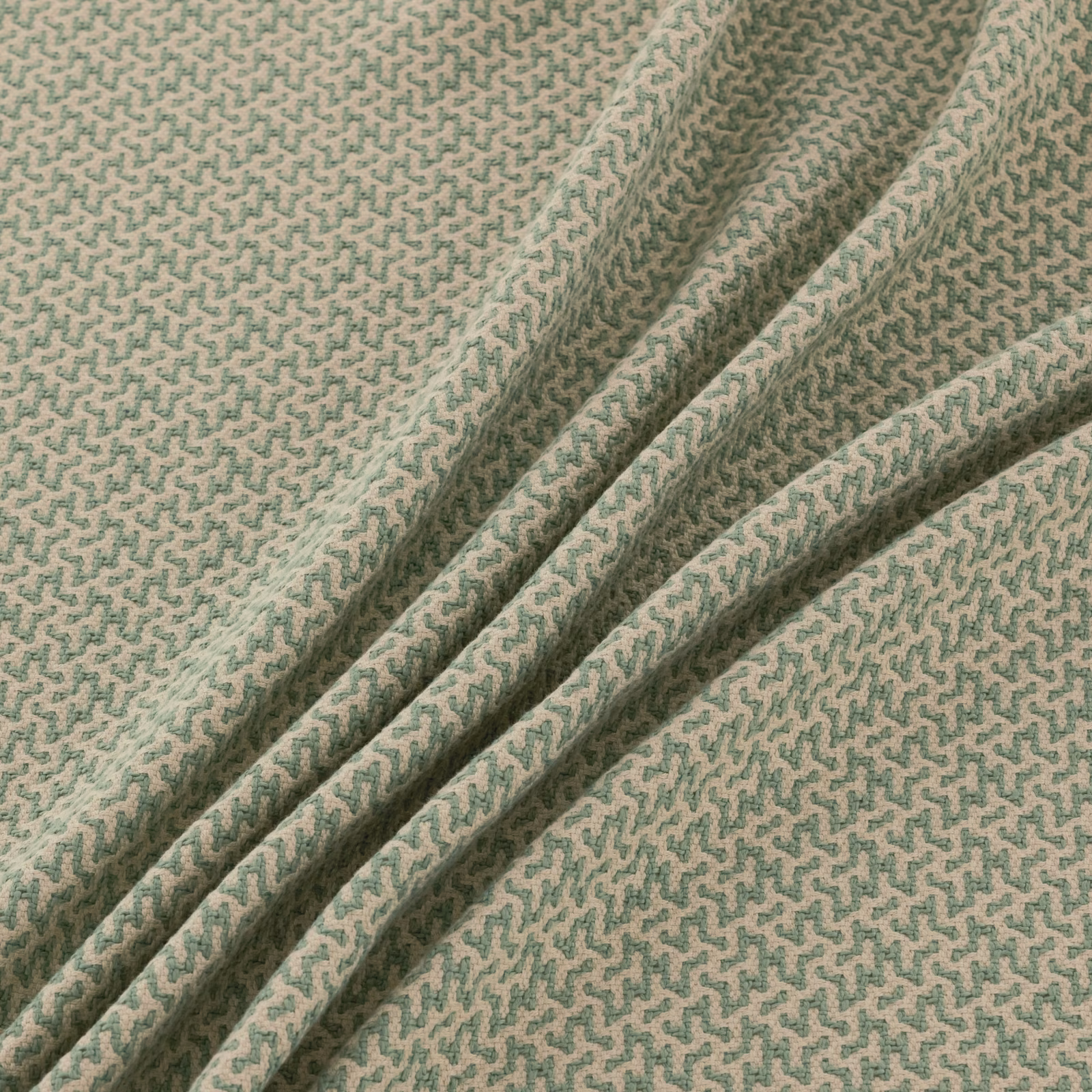 Pale sage and beige small meander textile folded into soft diagonal pleats