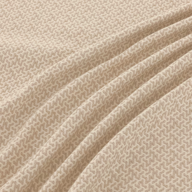 Pale gull-beige textile with a fine taupe meandering weave in gathered folds