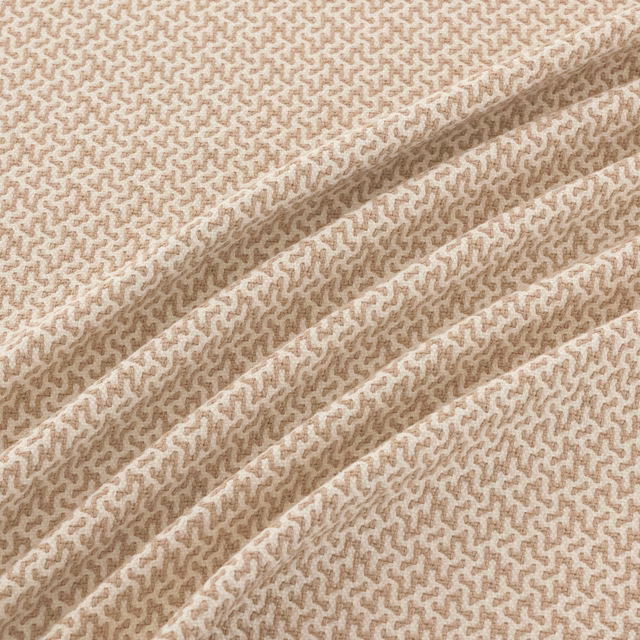 Warm beige and cream woven swatch with small meandering texture across soft folds